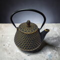 Kvalitný liatinový čajník s nerezovým filtrom a vnútorným smaltovaním, motív Kikko (včelí plást). Čierno-zlatá farba, objem 1,0 l.